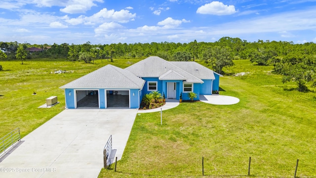 156 Puddle Duck Ln, Grant-Valkaria, FL 32909 - view of front facade featuring concrete driveway, a front lawn, and an attached garage