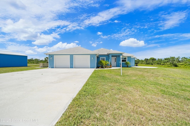 156 Puddle Duck Ln, Grant-Valkaria, FL 32909 - ranch-style house with an attached garage, driveway, a front lawn, and stucco siding