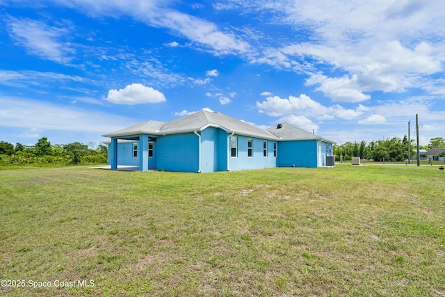 156 Puddle Duck Ln, Grant-Valkaria, FL 32909 - rear view of property with a lawn and stucco siding