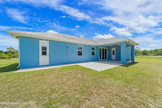 156 Puddle Duck Ln, Grant-Valkaria, FL 32909 - back of property featuring a patio, a ceiling fan, stucco siding, and a lawn