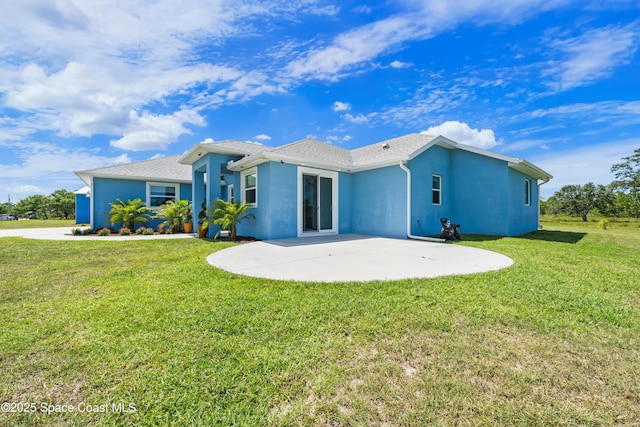 156 Puddle Duck Ln, Grant-Valkaria, FL 32909 - rear view of house featuring a patio, a lawn, and stucco siding