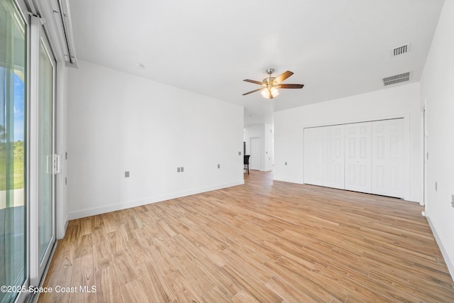 156 Puddle Duck Ln, Grant-Valkaria, FL 32909 - unfurnished living room with ceiling fan, light wood-type flooring, and plenty of natural light
