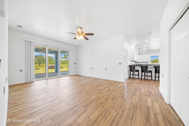 156 Puddle Duck Ln, Grant-Valkaria, FL 32909 - unfurnished living room featuring ceiling fan, light wood finished floors, and recessed lighting