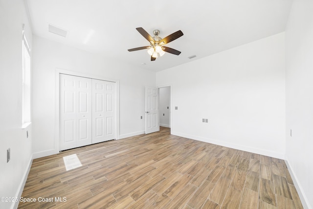 156 Puddle Duck Ln, Grant-Valkaria, FL 32909 - unfurnished bedroom with light wood-style floors, a closet, and ceiling fan