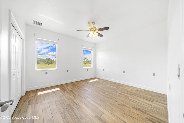 156 Puddle Duck Ln, Grant-Valkaria, FL 32909 - unfurnished bedroom with light wood-type flooring and ceiling fan