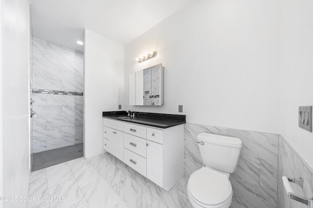 156 Puddle Duck Ln, Grant-Valkaria, FL 32909 - bathroom with marble finish flooring, vanity, walk in shower, wainscoting, and tile walls