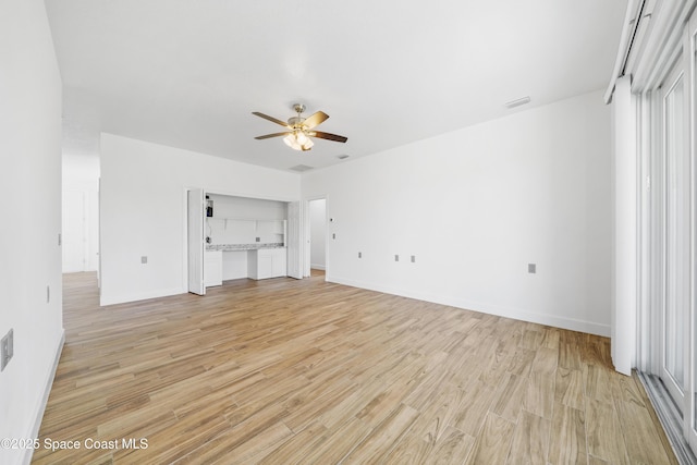 156 Puddle Duck Ln, Grant-Valkaria, FL 32909 - unfurnished living room with a ceiling fan and light wood-style flooring