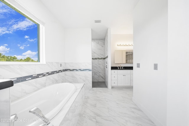 156 Puddle Duck Ln, Grant-Valkaria, FL 32909 - bathroom featuring vanity, marble finish floors, a bath, and a shower