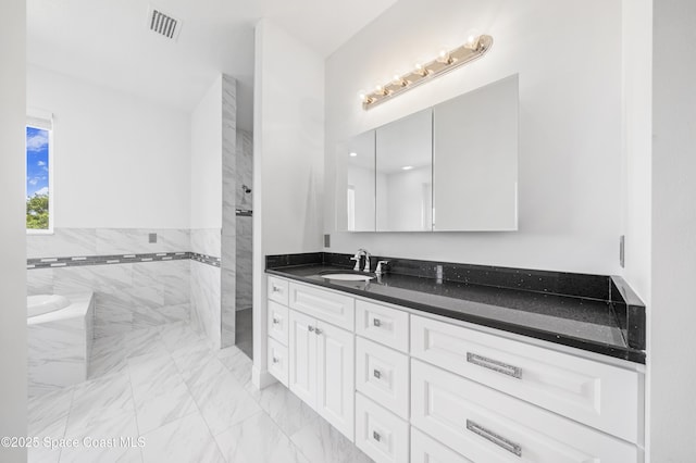 156 Puddle Duck Ln, Grant-Valkaria, FL 32909 - bathroom featuring marble finish flooring, vanity, a shower, and a tub