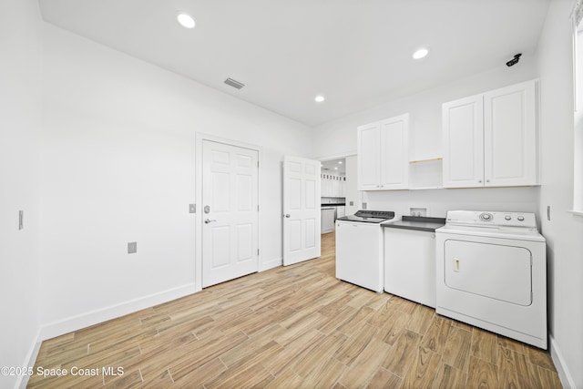 156 Puddle Duck Ln, Grant-Valkaria, FL 32909 - laundry area with cabinet space, light wood-type flooring, recessed lighting, and independent washer and dryer