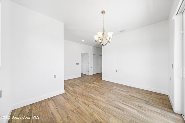156 Puddle Duck Ln, Grant-Valkaria, FL 32909 - empty room featuring a chandelier, light wood-style floors, and recessed lighting