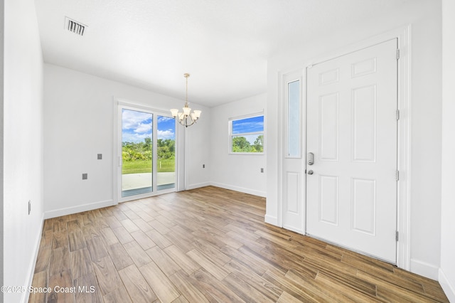 156 Puddle Duck Ln, Grant-Valkaria, FL 32909 - empty room featuring a chandelier and wood finished floors