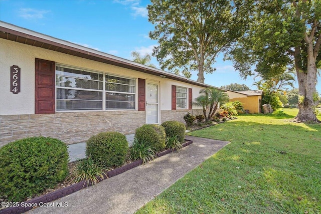 3664 Longbow Rd, Cocoa, FL 32926 - single story home featuring a front yard, stone siding, and stucco siding