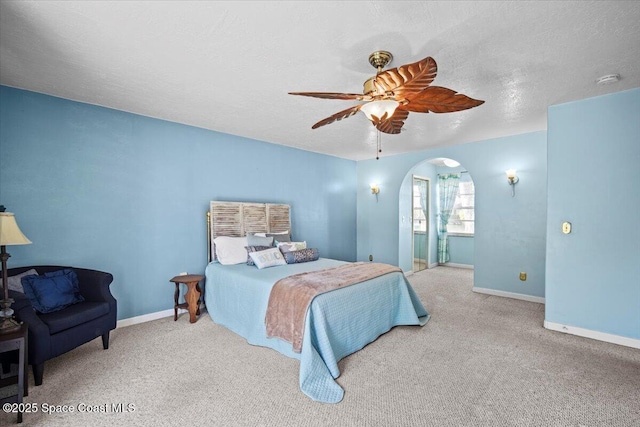 3664 Longbow Rd, Cocoa, FL 32926 - carpeted bedroom with arched walkways, ceiling fan, and a textured ceiling