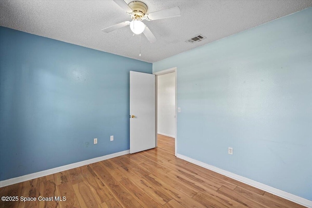 3664 Longbow Rd, Cocoa, FL 32926 - empty room with ceiling fan, wood finished floors, and a textured ceiling