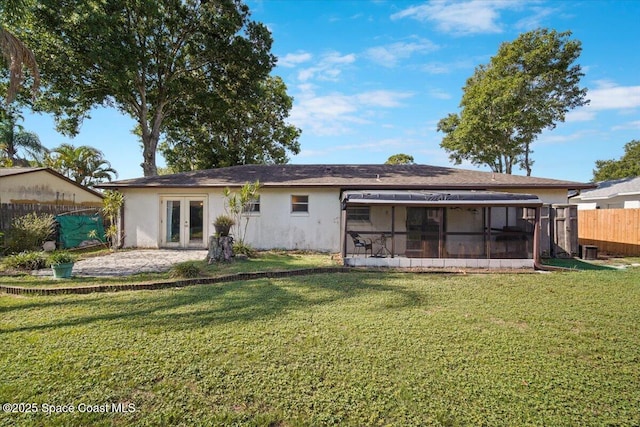 3664 Longbow Rd, Cocoa, FL 32926 - back of property with french doors, a sunroom, and stucco siding