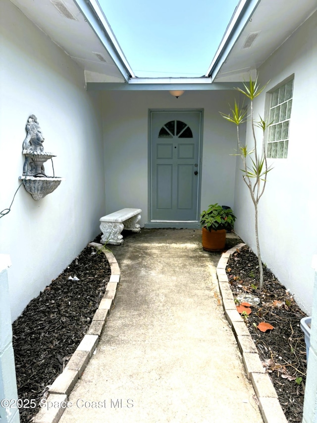 292 Pine Tree Dr, Indialantic, FL 32903 - view of exterior entry with stucco siding