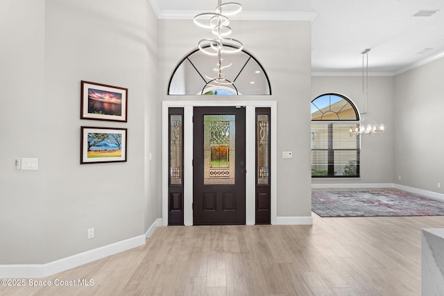 7987 Bradwick Way, Melbourne, FL 32940 - foyer featuring a chandelier, light wood-style floors, and crown molding