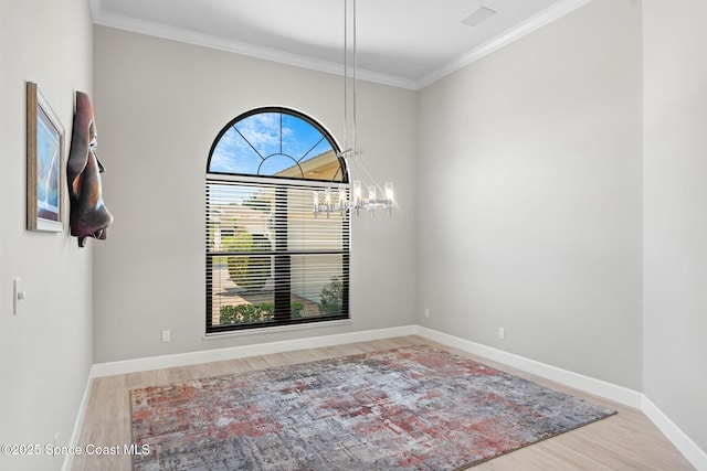 7987 Bradwick Way, Melbourne, FL 32940 - unfurnished room featuring wood finished floors, a chandelier, and ornamental molding