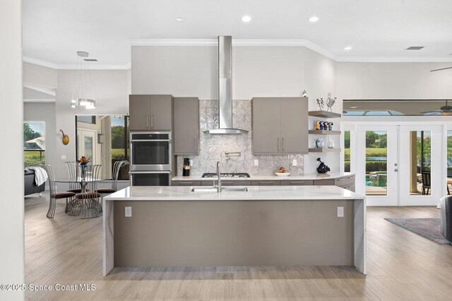 7987 Bradwick Way, Melbourne, FL 32940 - kitchen with gray cabinetry, appliances with stainless steel finishes, open shelves, ornamental molding, and wall chimney range hood