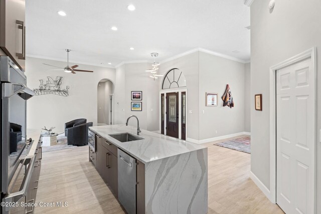 7987 Bradwick Way, Melbourne, FL 32940 - kitchen featuring open floor plan, arched walkways, dishwasher, a ceiling fan, and light wood-style floors