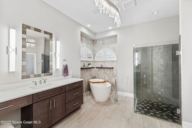 7987 Bradwick Way, Melbourne, FL 32940 - full bath featuring a shower stall, vanity, a freestanding tub, and recessed lighting