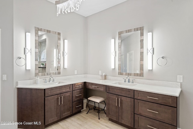 7987 Bradwick Way, Melbourne, FL 32940 - bathroom with double vanity and wood finished floors
