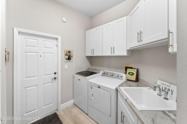 7987 Bradwick Way, Melbourne, FL 32940 - laundry room featuring washer and clothes dryer, cabinet space, and light wood-type flooring