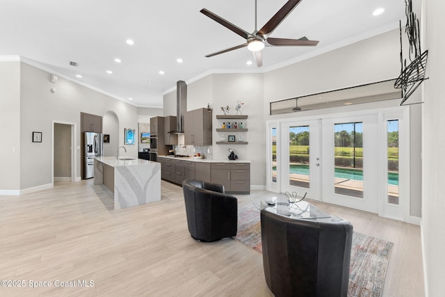 7987 Bradwick Way, Melbourne, FL 32940 - living area with recessed lighting, ornamental molding, a towering ceiling, a ceiling fan, and arched walkways