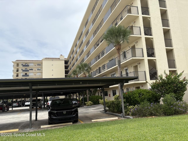 520 Palm Springs Blvd Unit 102, Indian Harbour Beach, FL 32937 - view of apartment building / complex with covered parking