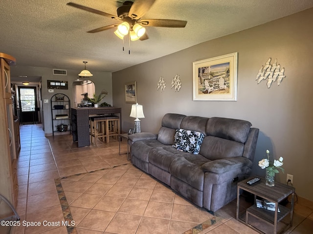 520 Palm Springs Blvd Unit 102, Indian Harbour Beach, FL 32937 - living room featuring a ceiling fan, light tile patterned flooring, and a textured ceiling
