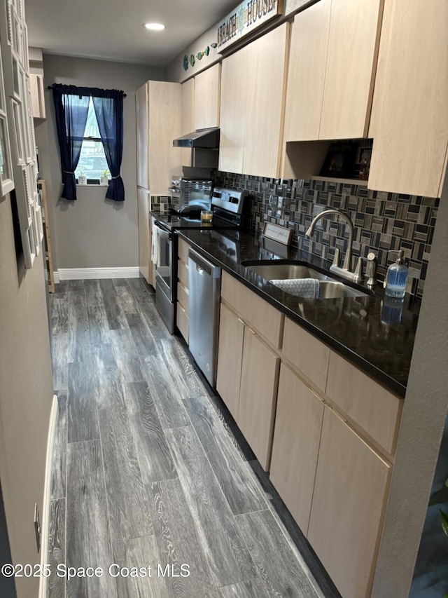 520 Palm Springs Blvd Unit 102, Indian Harbour Beach, FL 32937 - kitchen featuring appliances with stainless steel finishes, range hood, light brown cabinetry, backsplash, and recessed lighting