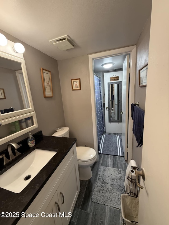520 Palm Springs Blvd Unit 102, Indian Harbour Beach, FL 32937 - full bath with vanity, wood finished floors, and curtained shower