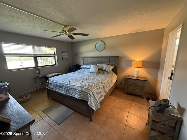 520 Palm Springs Blvd Unit 102, Indian Harbour Beach, FL 32937 - bedroom featuring a textured ceiling, light tile patterned flooring, and a ceiling fan