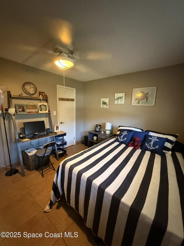 520 Palm Springs Blvd Unit 102, Indian Harbour Beach, FL 32937 - tiled bedroom featuring ceiling fan