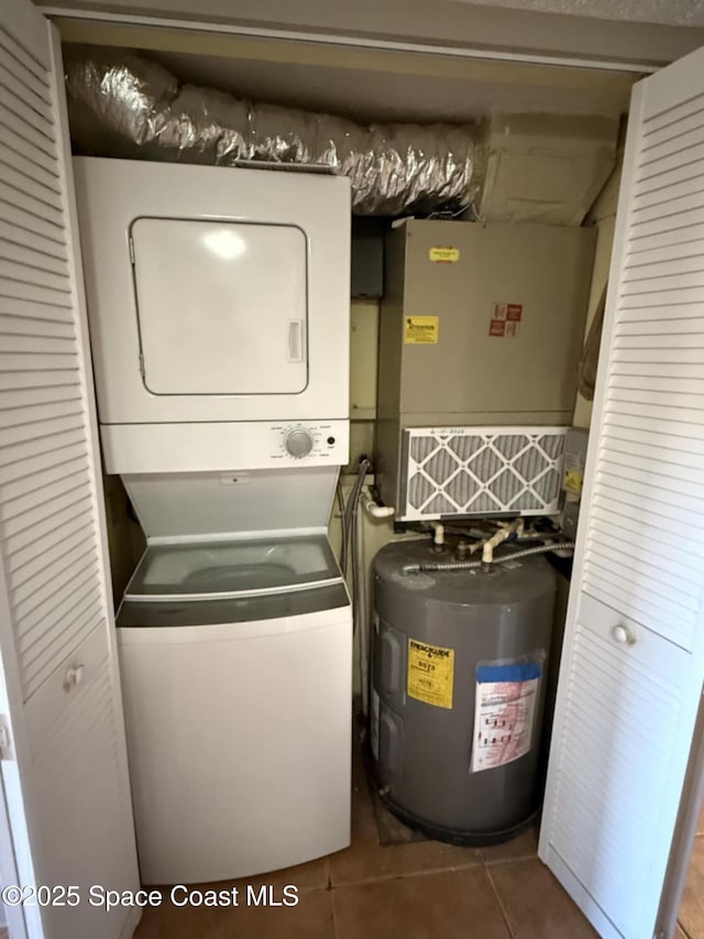 520 Palm Springs Blvd Unit 102, Indian Harbour Beach, FL 32937 - laundry room featuring stacked washing machine and dryer, water heater, tile patterned flooring, and heating unit