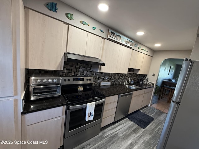520 Palm Springs Blvd Unit 102, Indian Harbour Beach, FL 32937 - kitchen featuring appliances with stainless steel finishes, under cabinet range hood, dark countertops, backsplash, and recessed lighting