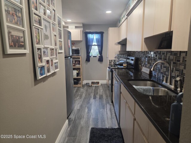 520 Palm Springs Blvd Unit 102, Indian Harbour Beach, FL 32937 - kitchen with appliances with stainless steel finishes, backsplash, dark stone countertops, recessed lighting, and dark wood finished floors