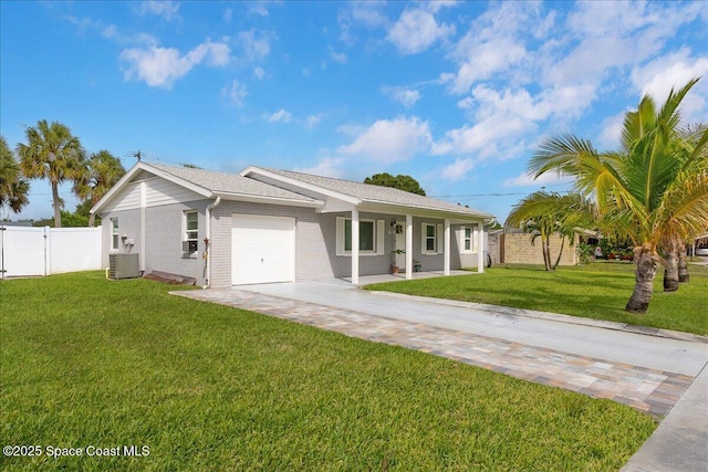 955 Bartlett Ln, Rockledge, FL 32955 - ranch-style house with a garage, driveway, covered porch, and brick siding