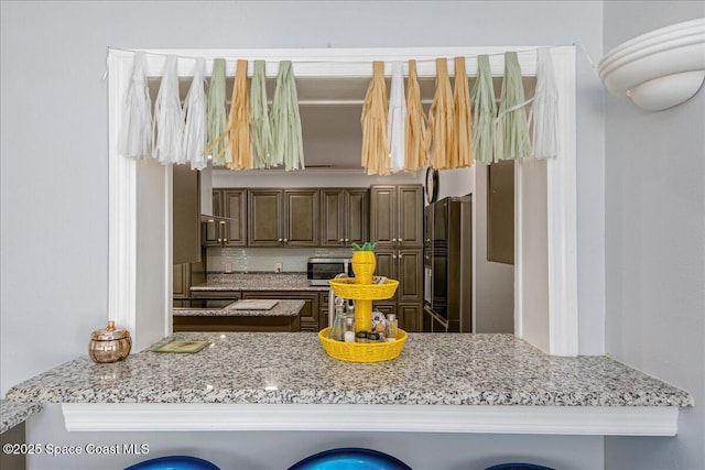 955 Bartlett Ln, Rockledge, FL 32955 - kitchen with appliances with stainless steel finishes, light stone counters, and tasteful backsplash