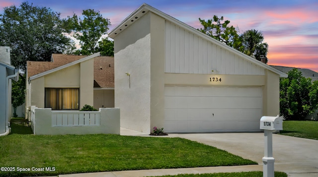 1734 Bluebird Ct, Melbourne, FL 32935 - mid-century inspired home with a front yard, driveway, a shingled roof, and stucco siding