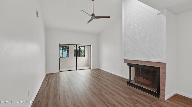 1734 Bluebird Ct, Melbourne, FL 32935 - unfurnished living room with wood finished floors, ceiling fan, a fireplace, and high vaulted ceiling