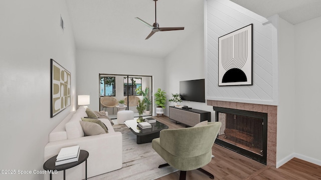 1734 Bluebird Ct, Melbourne, FL 32935 - living room with wood finished floors, high vaulted ceiling, a ceiling fan, and a tiled fireplace