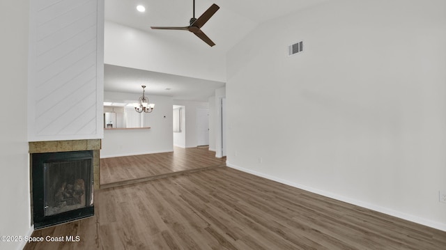 1734 Bluebird Ct, Melbourne, FL 32935 - unfurnished living room featuring wood finished floors, a chandelier, ceiling fan, a fireplace, and high vaulted ceiling