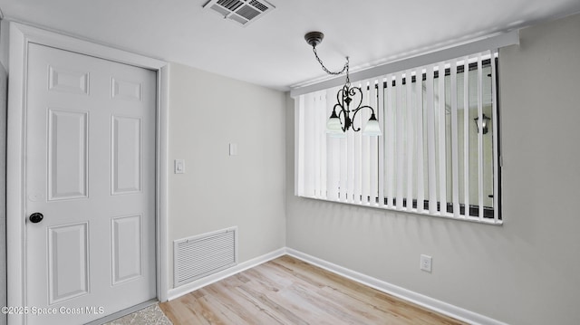 1734 Bluebird Ct, Melbourne, FL 32935 - unfurnished dining area featuring a chandelier and wood finished floors