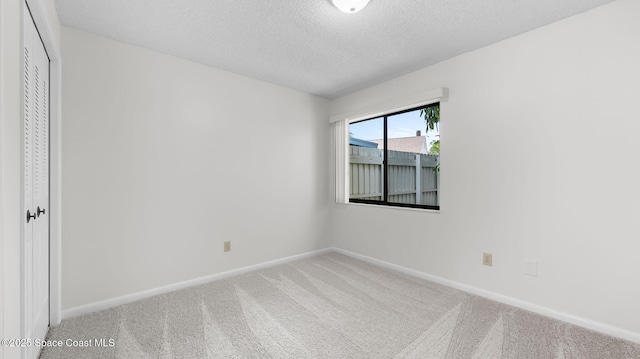 1734 Bluebird Ct, Melbourne, FL 32935 - carpeted empty room featuring baseboards and a textured ceiling