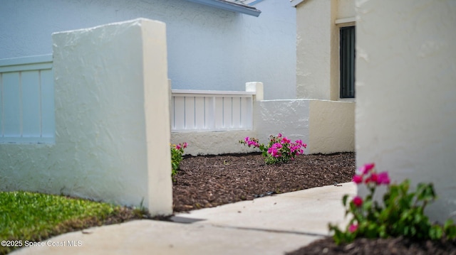 1734 Bluebird Ct, Melbourne, FL 32935 - view of home's exterior with stucco siding and a patio area