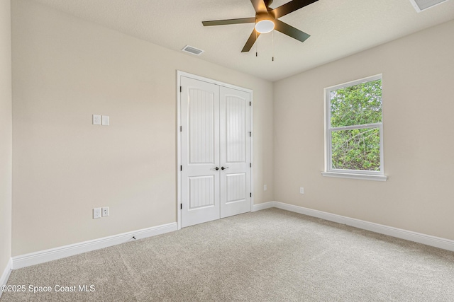 8025 Babcock St SE, Grant-Valkaria, FL 32909 - unfurnished bedroom with carpet, a closet, and a ceiling fan