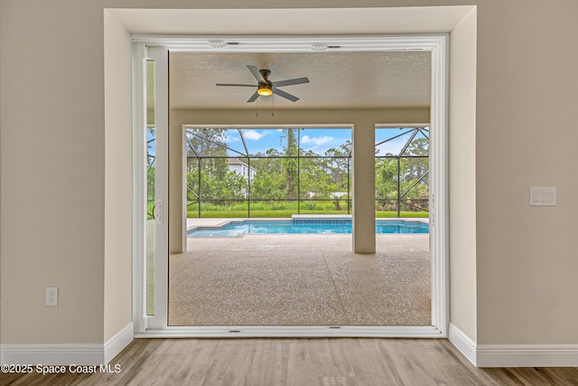8025 Babcock St SE, Grant-Valkaria, FL 32909 - doorway to outside with a ceiling fan, wood finished floors, and healthy amount of natural light