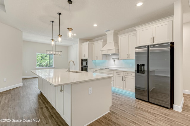 8025 Babcock St SE, Grant-Valkaria, FL 32909 - kitchen featuring appliances with stainless steel finishes, custom range hood, white cabinetry, light wood-style floors, and recessed lighting